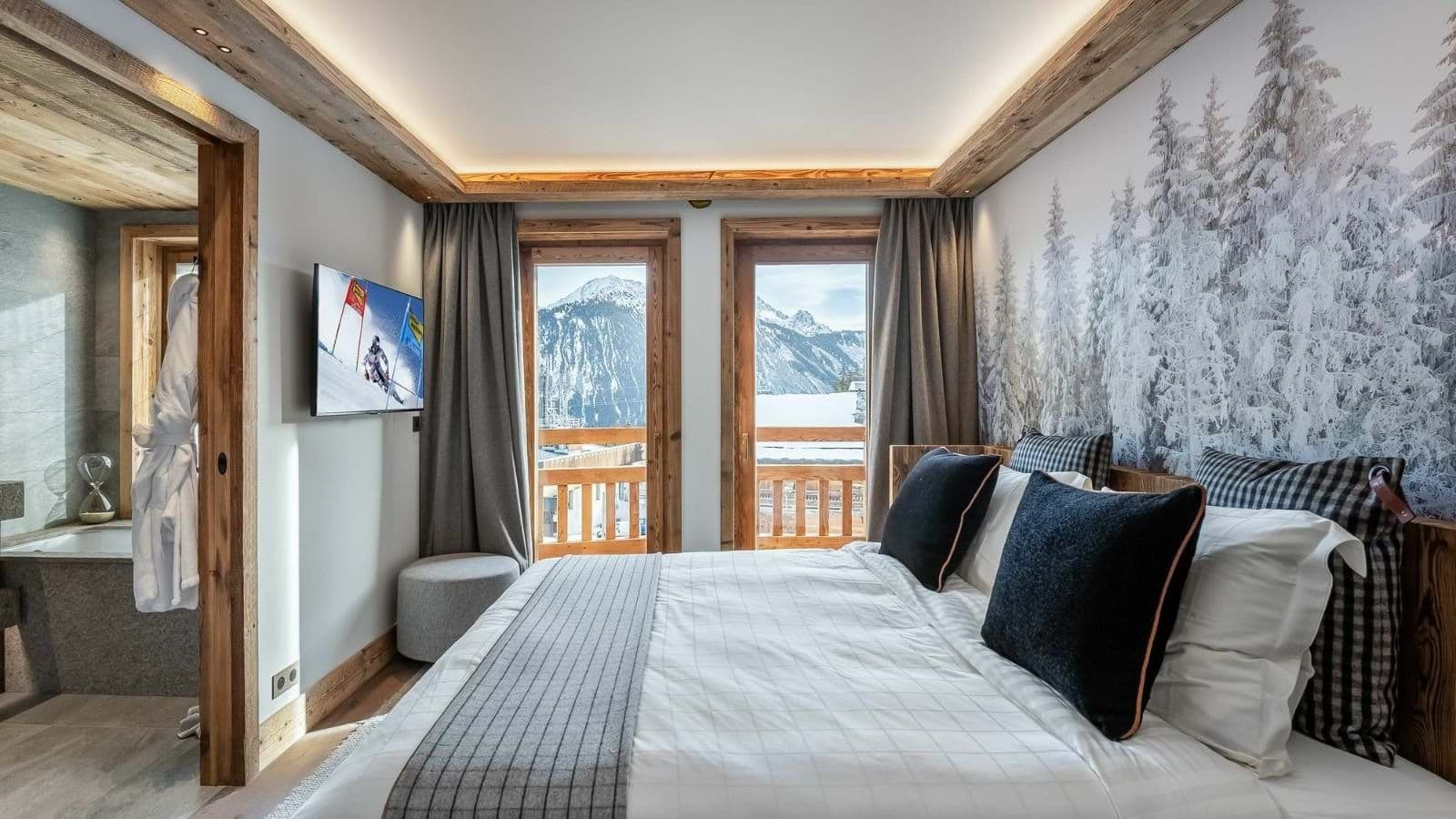 Primary bedroom with mountain views and en-suite bathroom with soaking tub