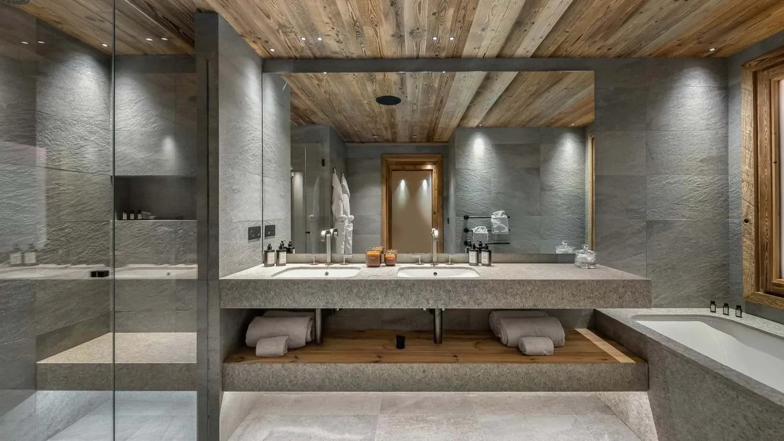 En-suite bathroom with a double basin, stone finishes and bathtub