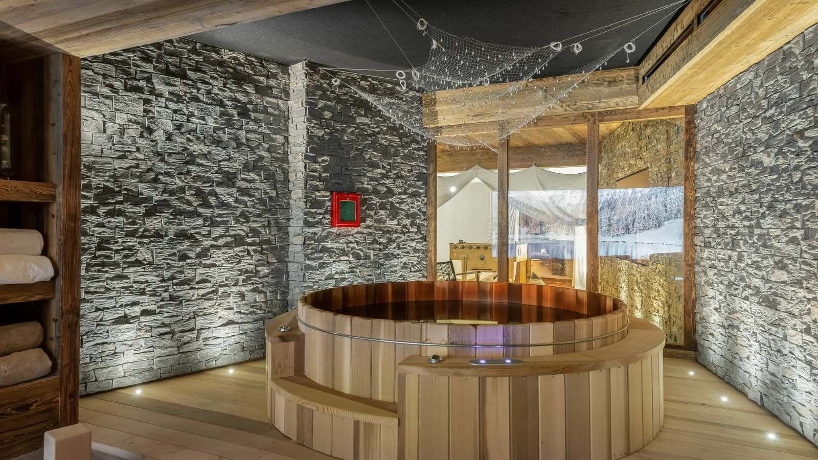 Indoor Nordic bath with timber seating and stone walls