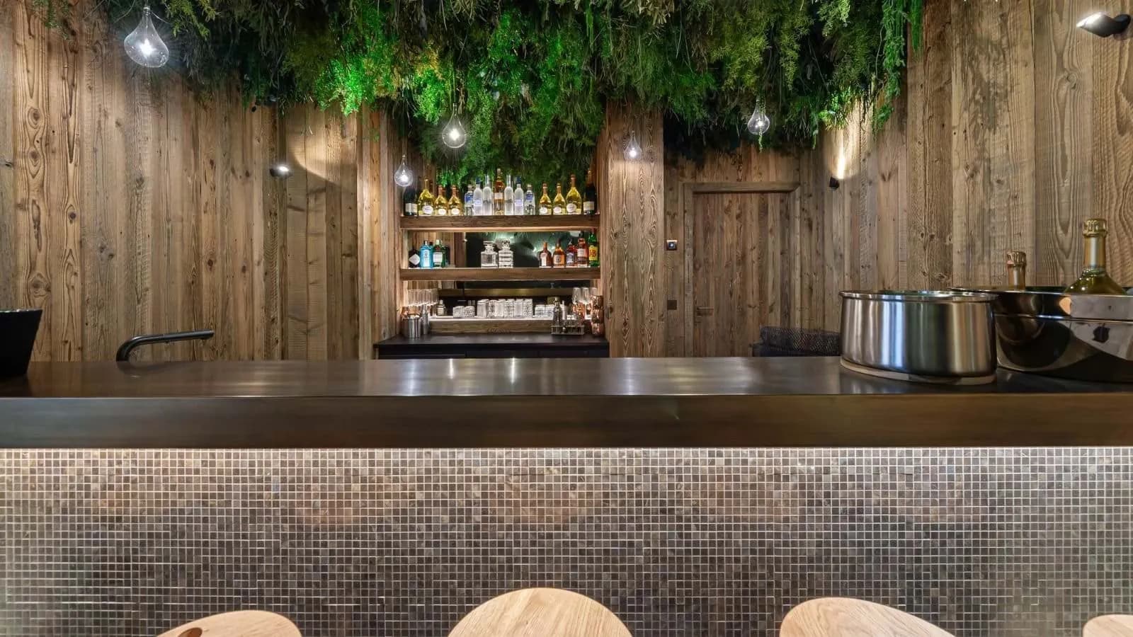 Private bar with timber panelling and a planted ceiling