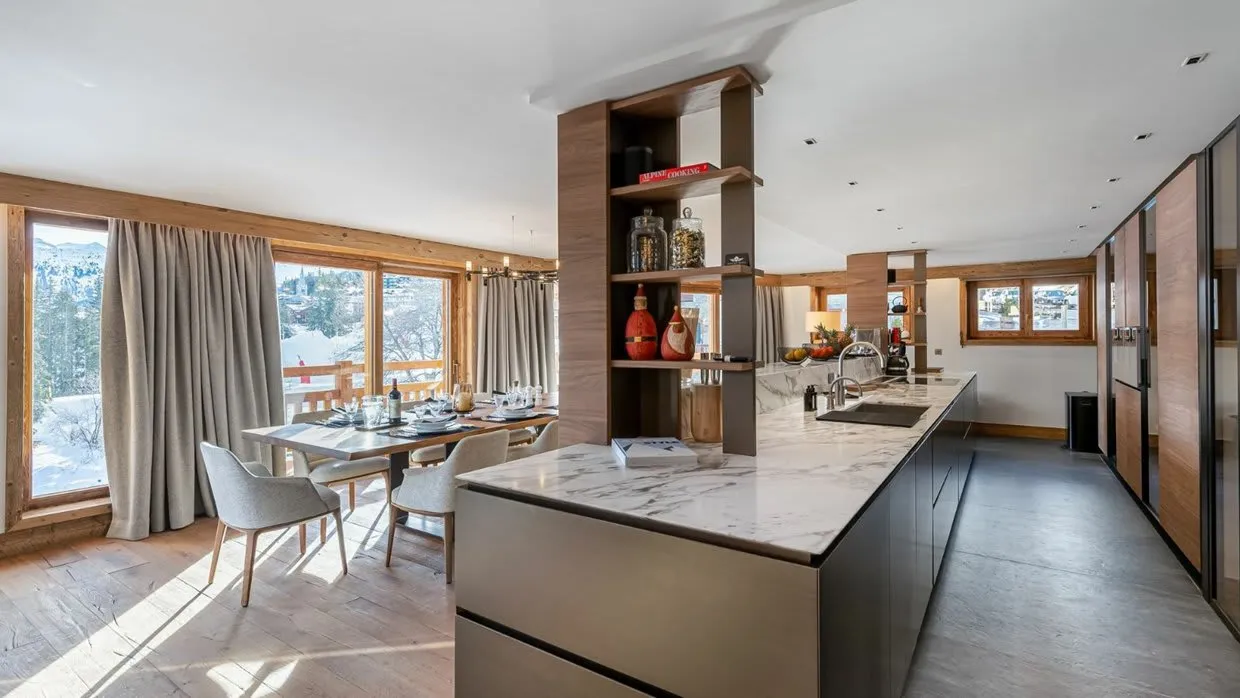 Open kitchen with a marble island beside the dining area