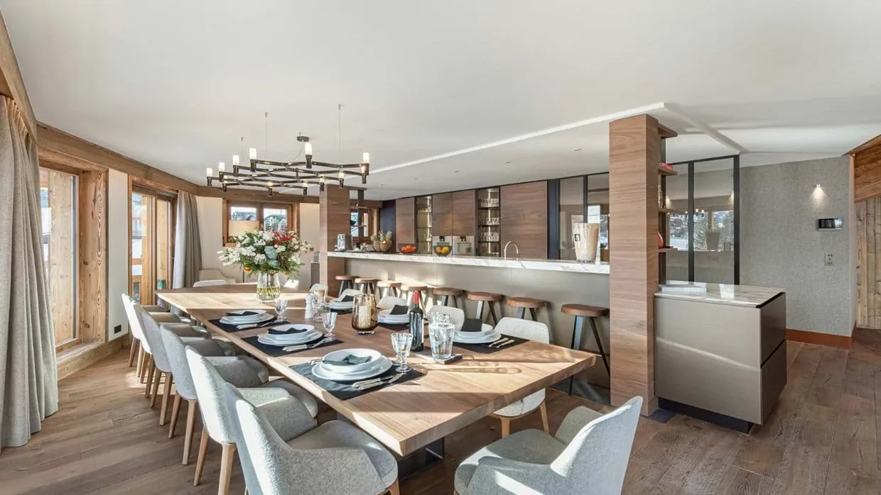 Dining area with a long table beside the open kitchen