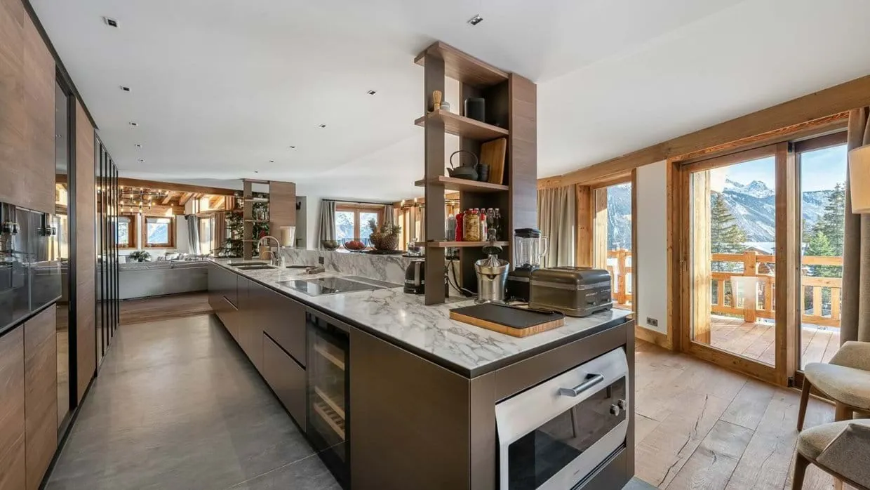 Kitchen island with marble worktops, wine storage and balcony access