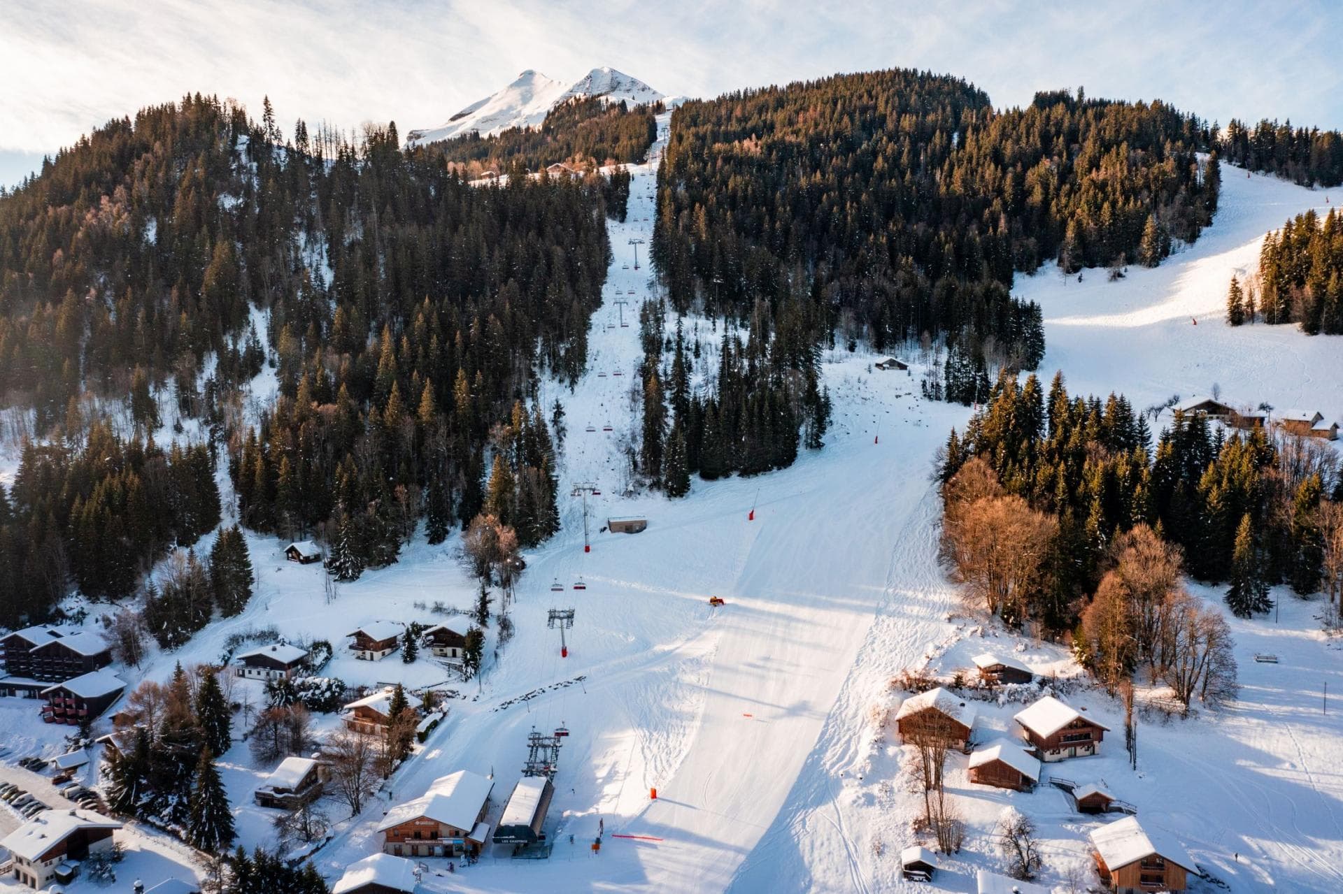Ski resort view with groomed runs and chairlift access