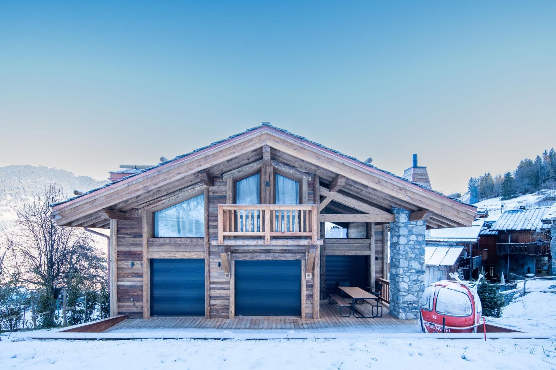 Two-car garage with covered carport; accessed from snow-covered drive