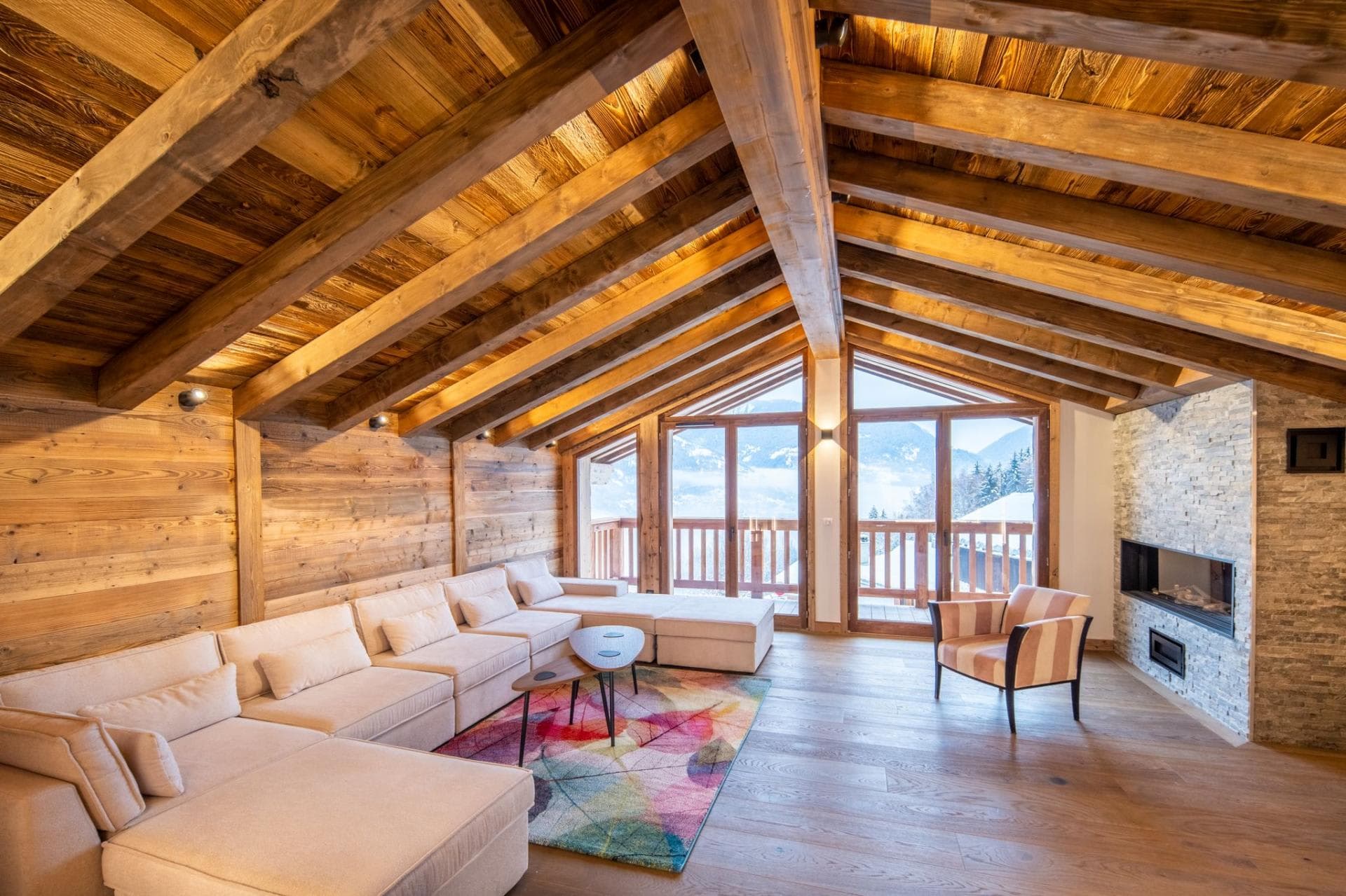 Living room with exposed beam ceilings, sectional seating for 8+, and mountain views