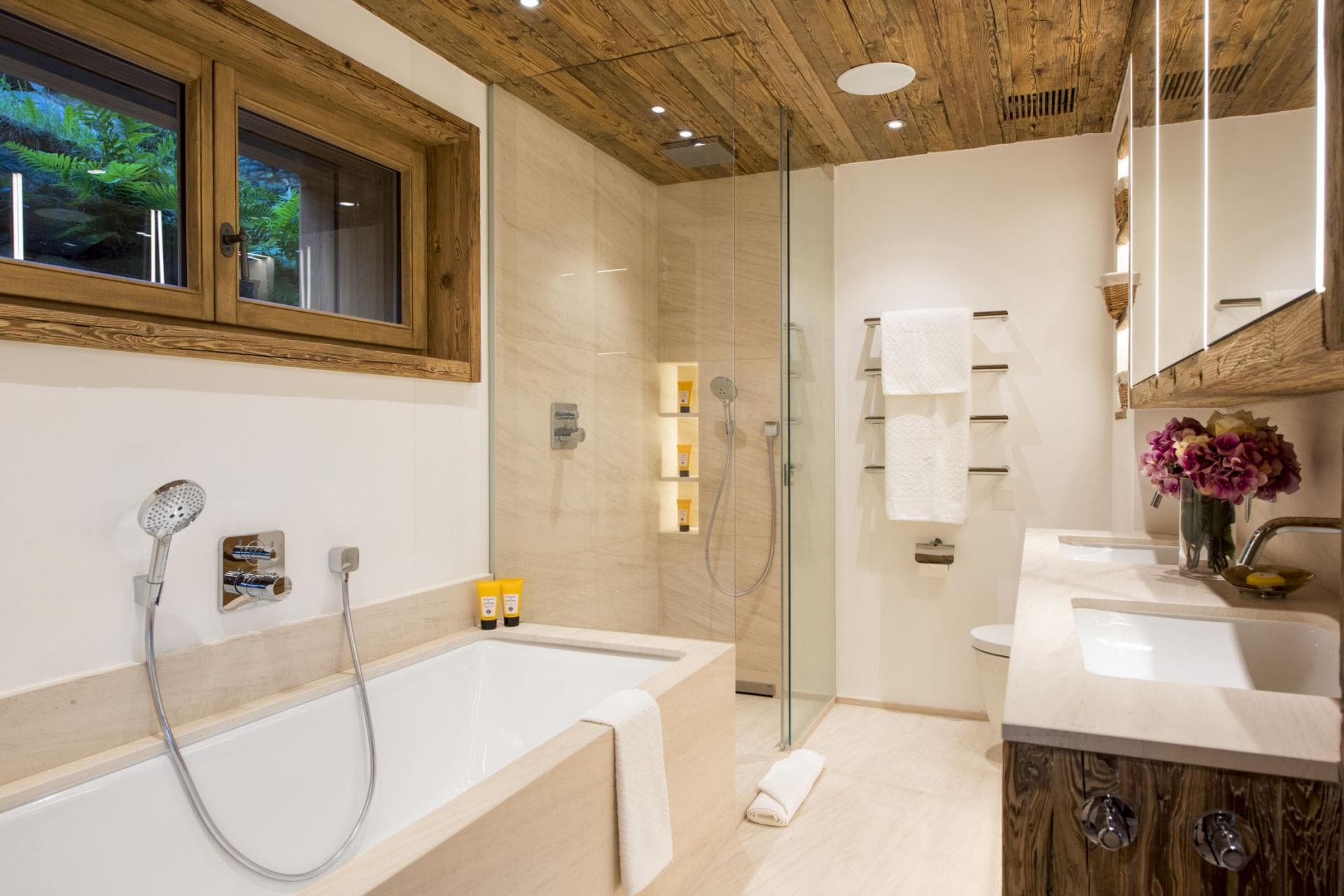 Bathroom with soaking tub, walk-in rainfall shower, and dual vanity