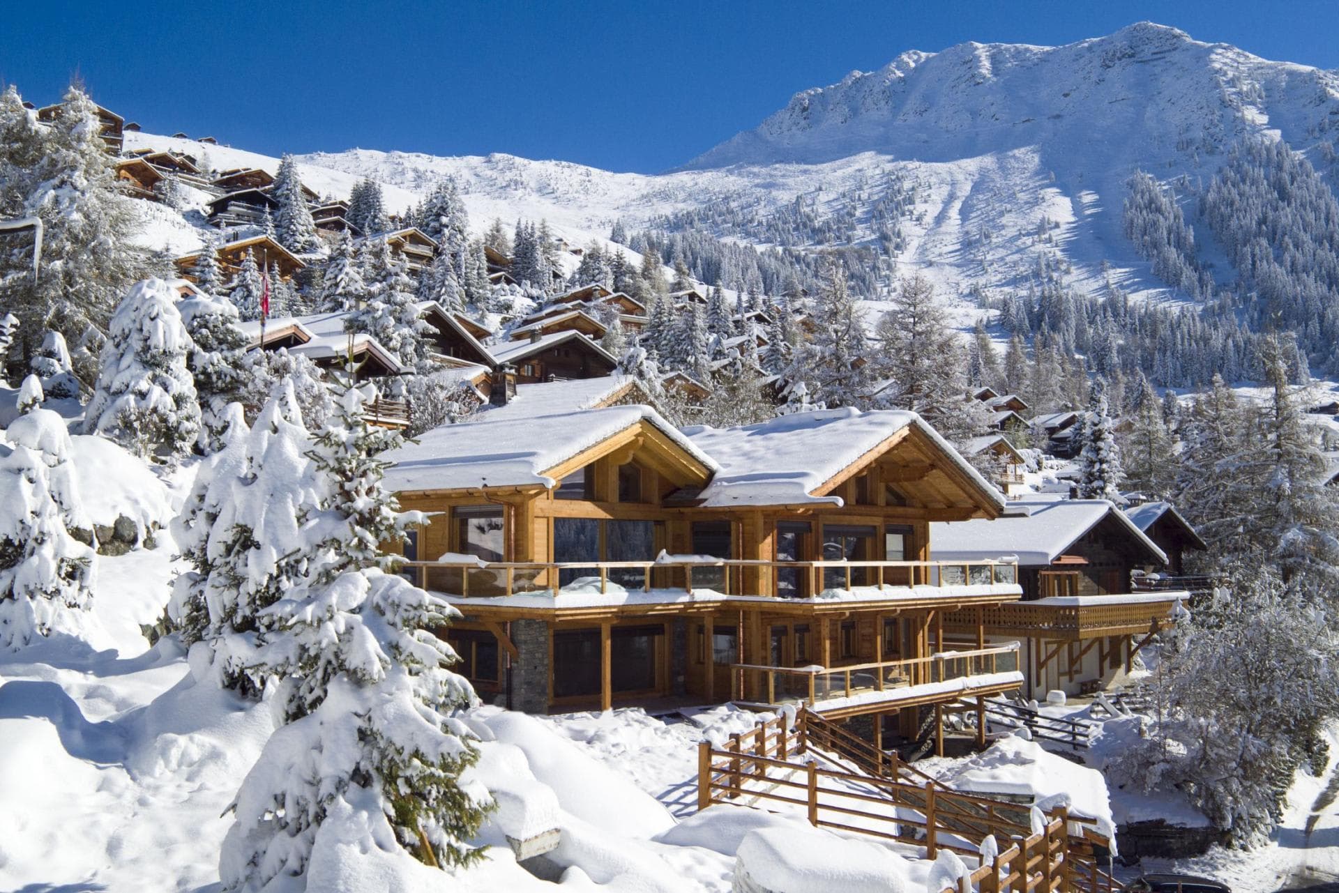 Ski-in, ski-out timber chalet with wrap-around balconies and mountain views