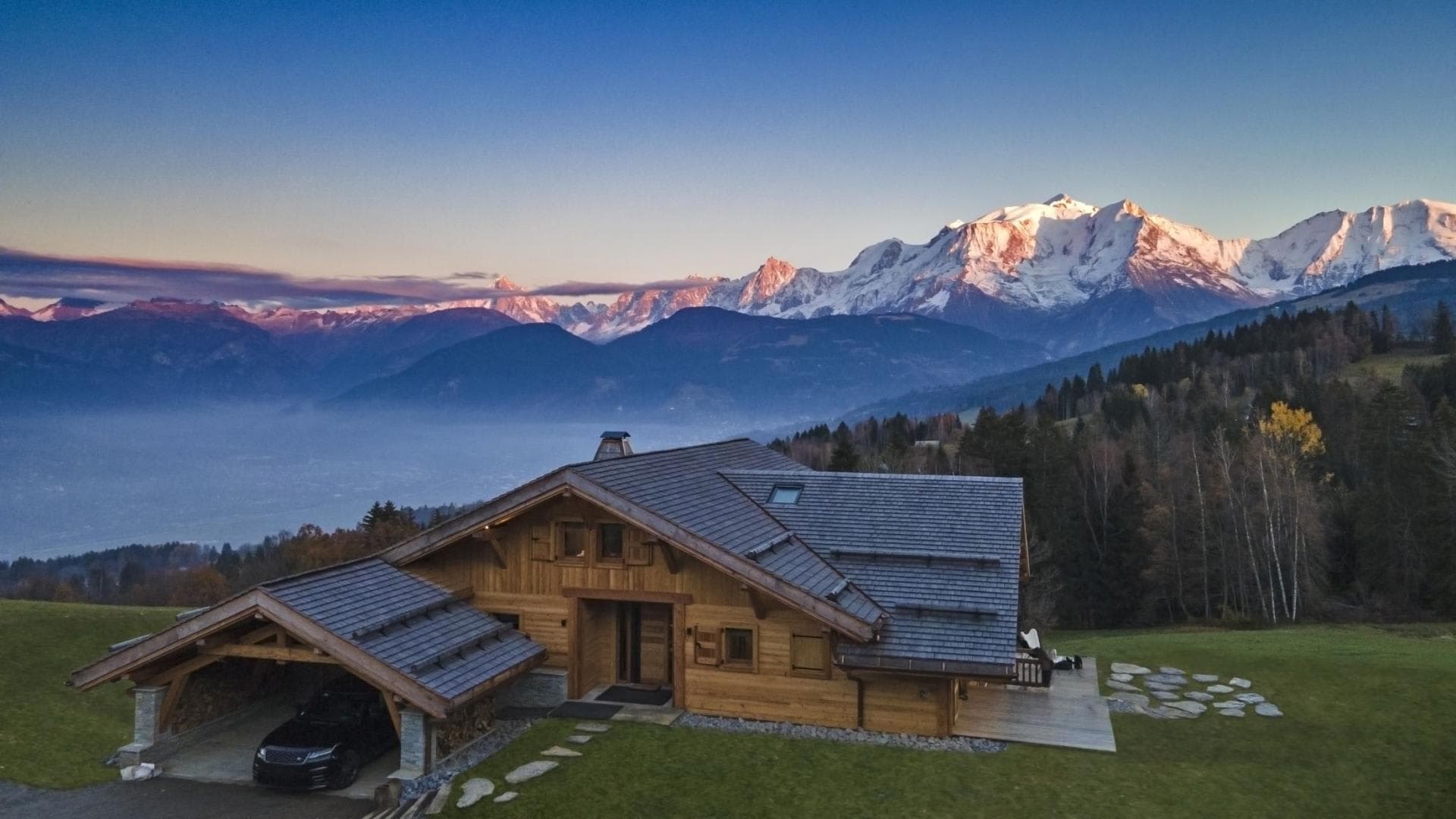 Chalet exterior with covered carport and panoramic Mont Blanc views