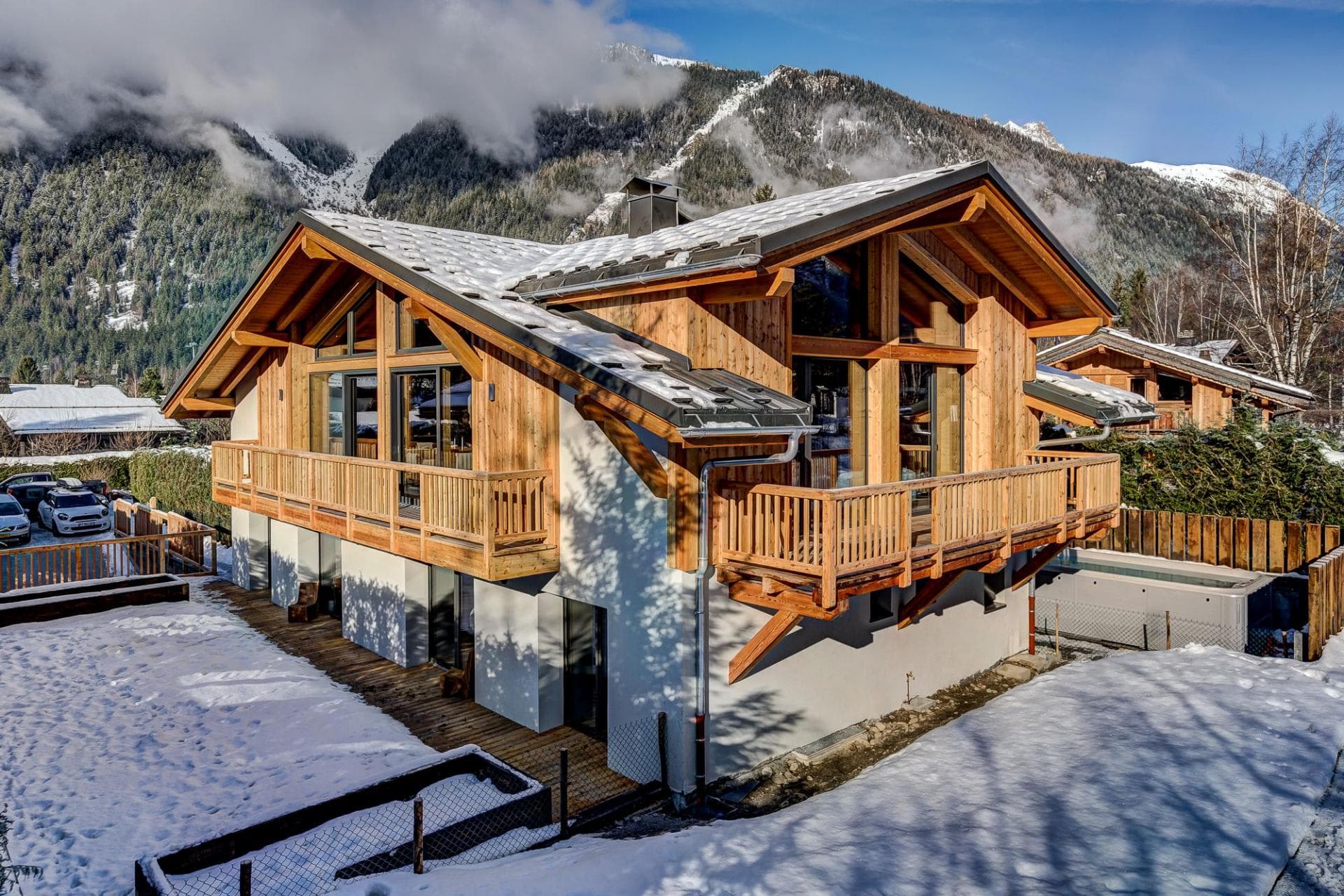 Chalet exterior with wrap-around balcony and private outdoor hot tub