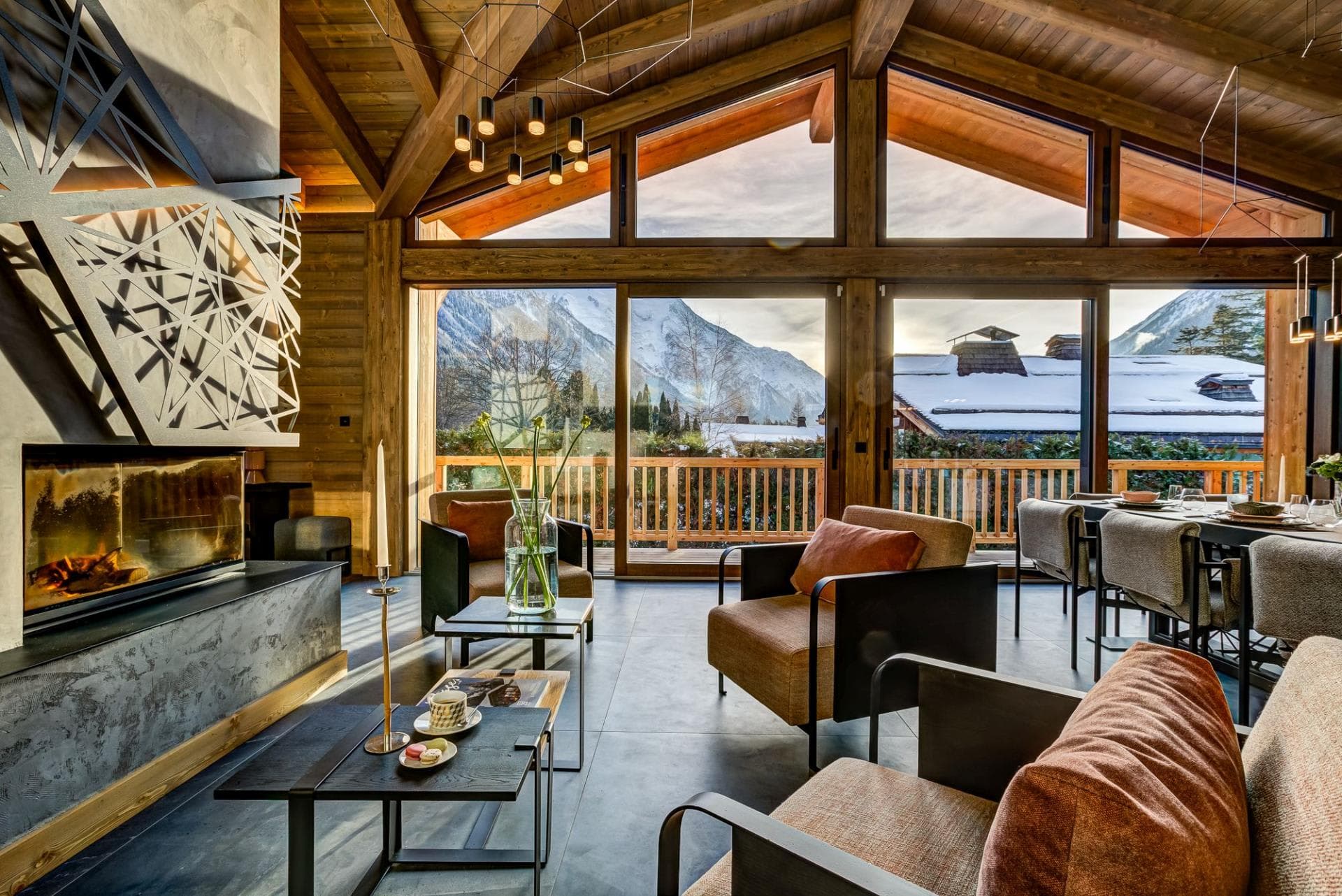 Open living area with wood-burning fireplace and floor-to-ceiling mountain views