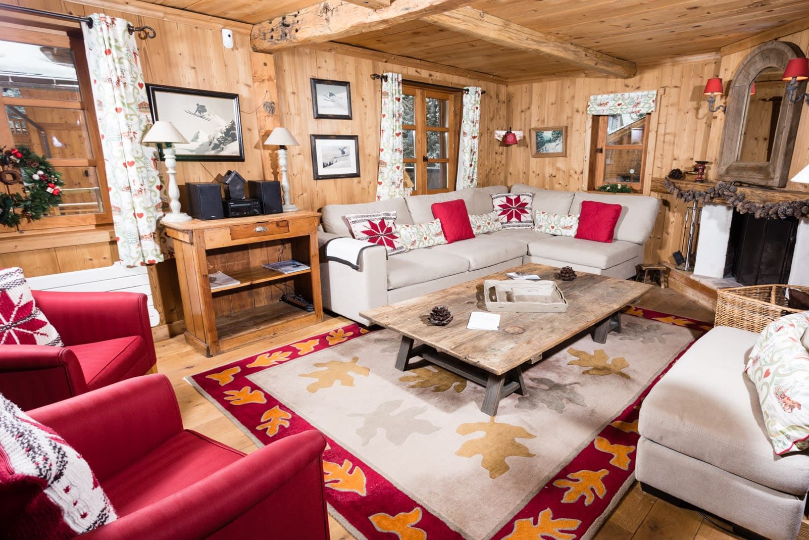 Wood-paneled living room featuring wood-burning fireplace and seating for 7
