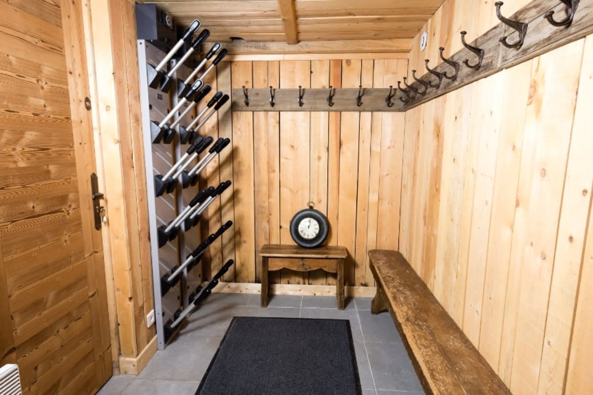 Ski room with electric boot warmers, bench, and gear hooks