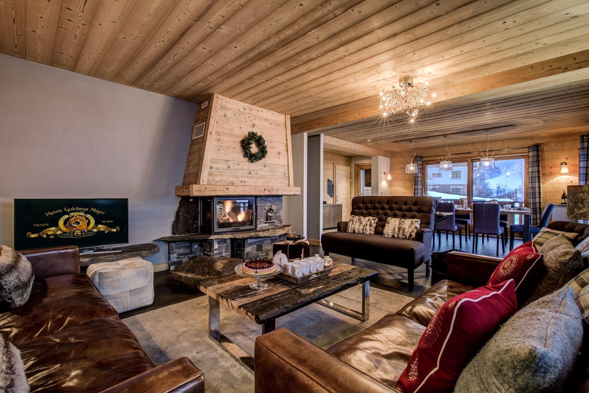 Living room with wood-burning fireplace and leather seating for 8