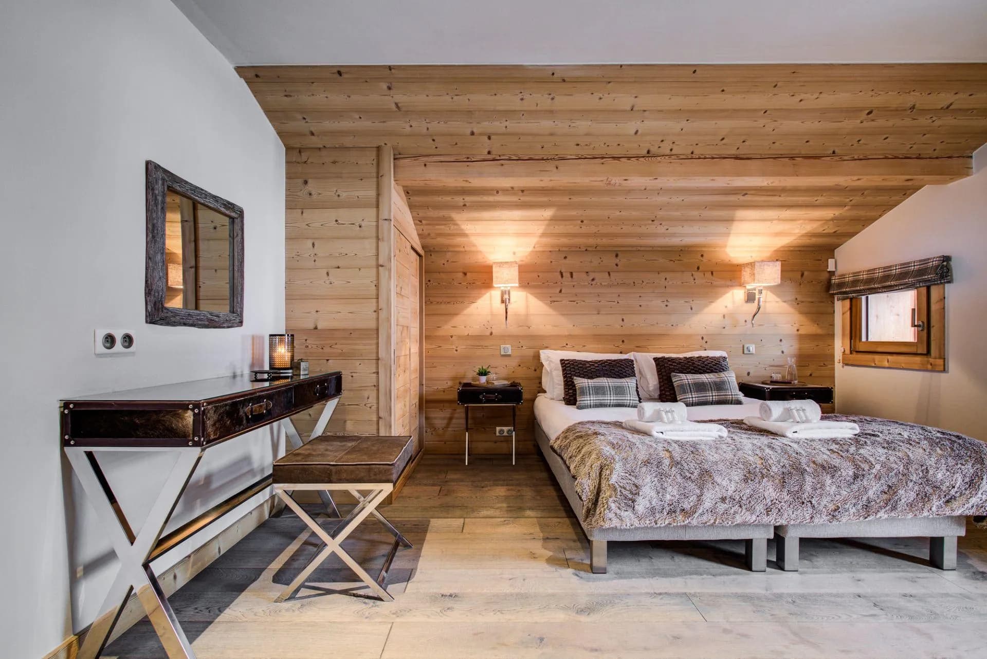 Double or twin bedroom with wood-panelled walls and a sloping ceiling