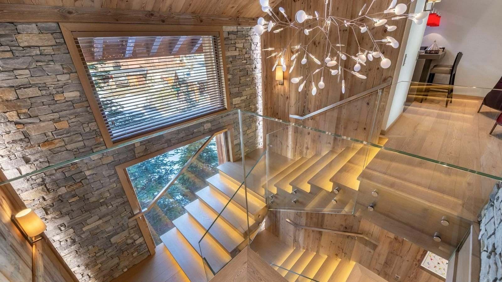 Staircase with integrated LED tread lighting and glass railings
