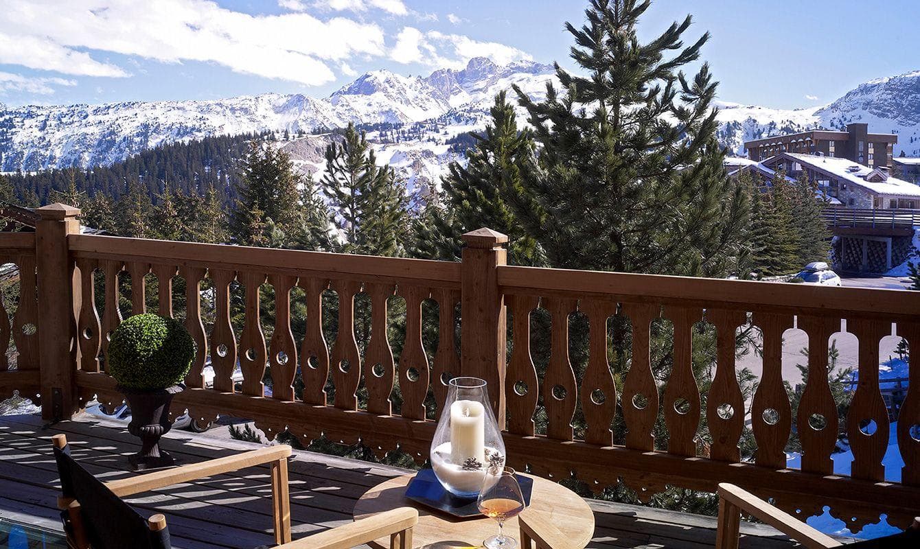 Private wooden balcony with lounge seating and panoramic mountain views