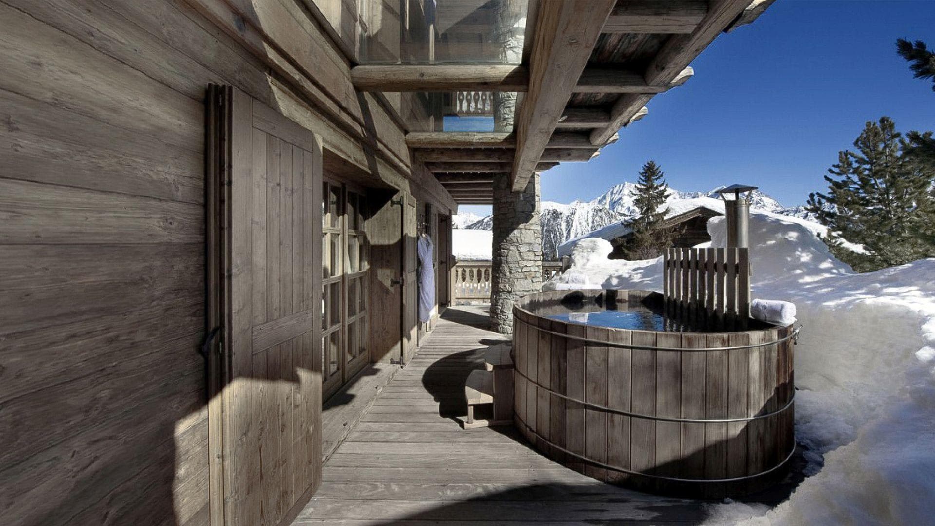 Cedar hot tub on covered deck with mountain views