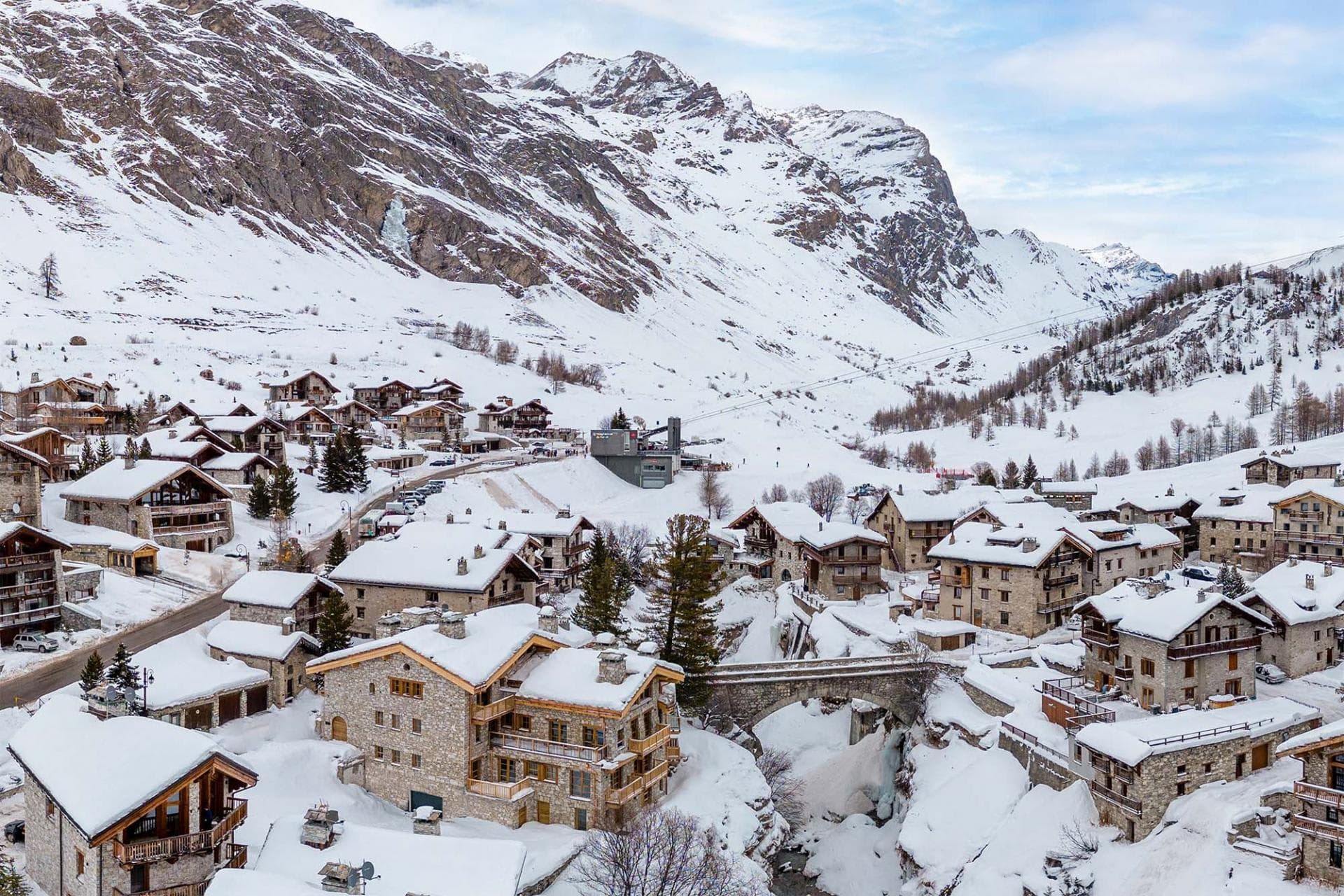 Ski-in village view with chalet proximity to cable car and bridge