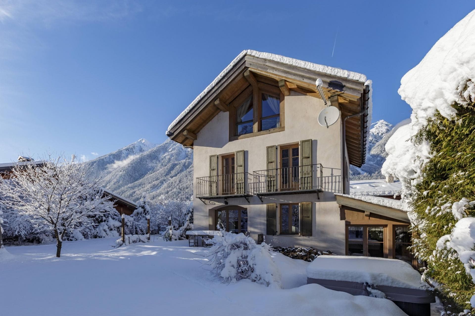Chalet exterior with private snowy garden and mountain views