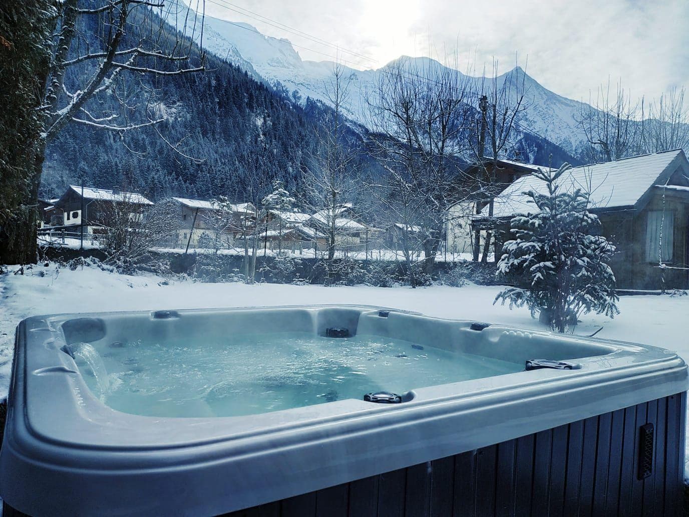 Outdoor hot tub with seating for 6 and mountain views