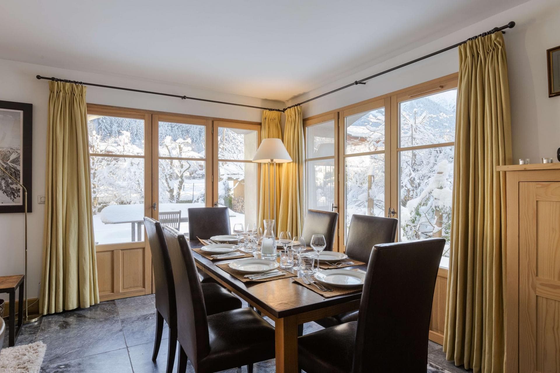 Dining area with seating for 6 and snowy garden views