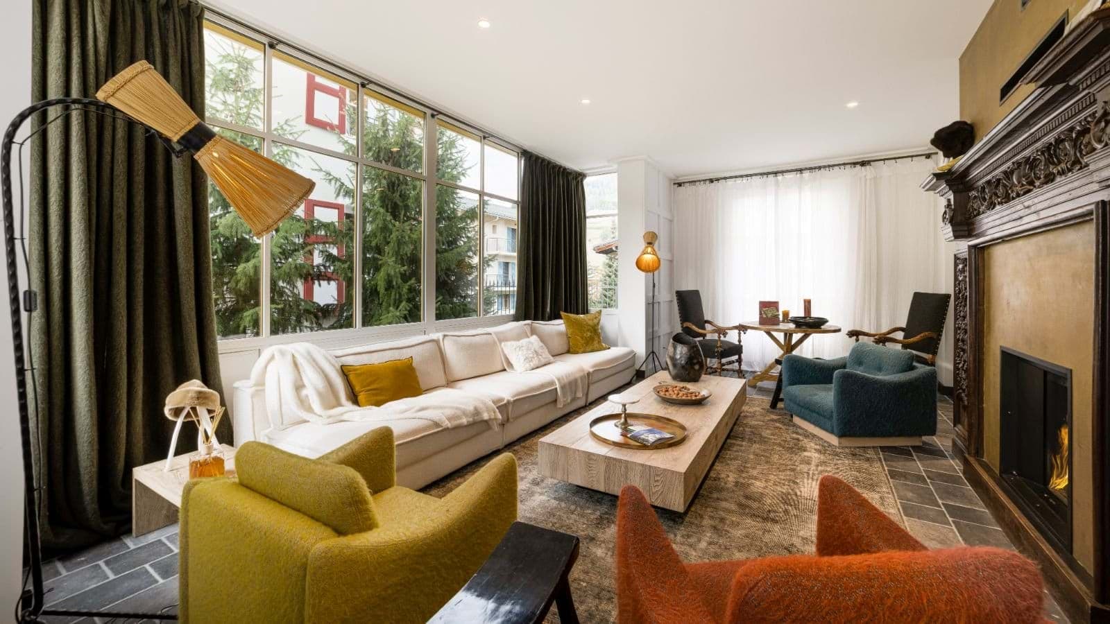 Living room with floor-to-ceiling windows and seating for 9