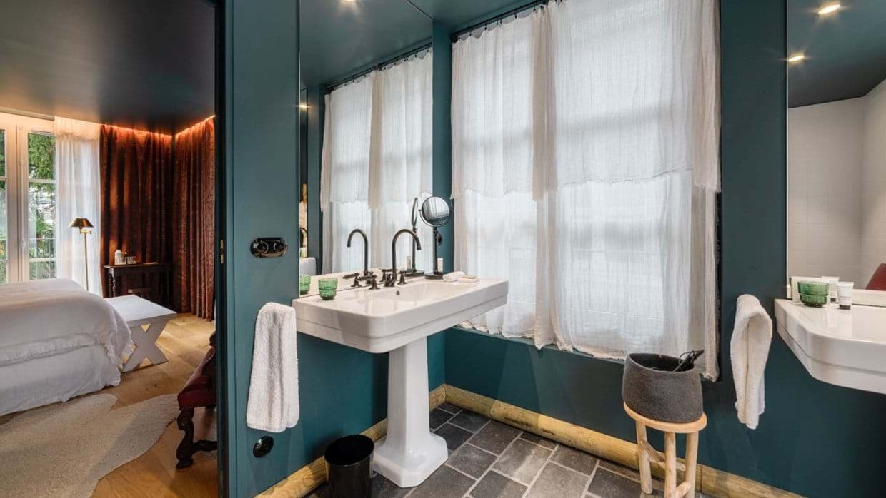 Bathroom with pedestal sink and slate tile flooring