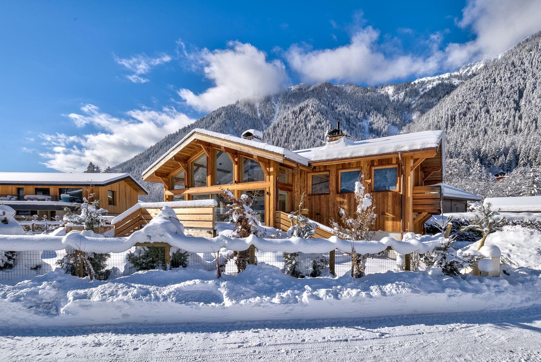 Chalet exterior with floor-to-ceiling windows and mountain views