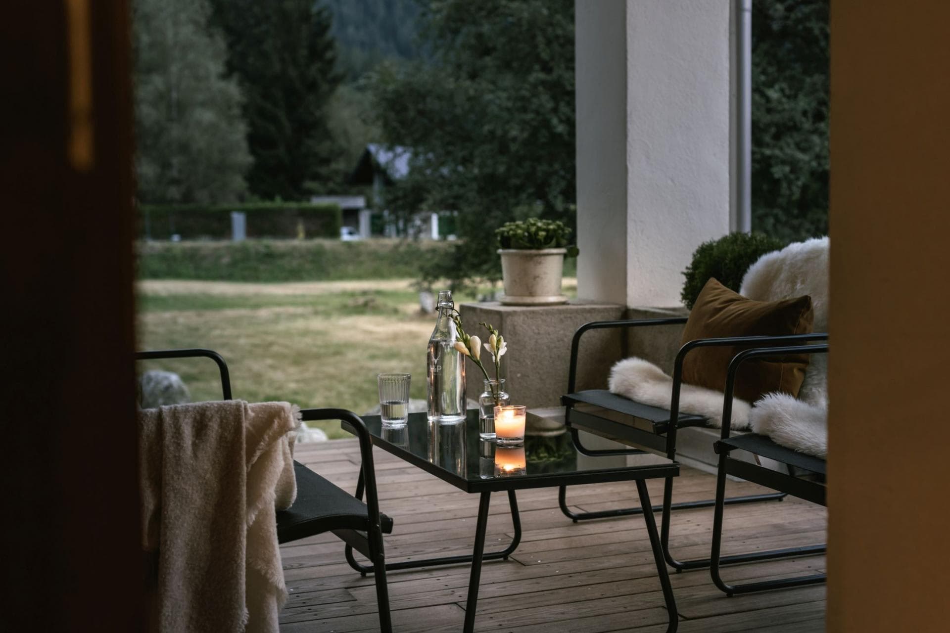 Covered terrace with lounge seating and meadow views
