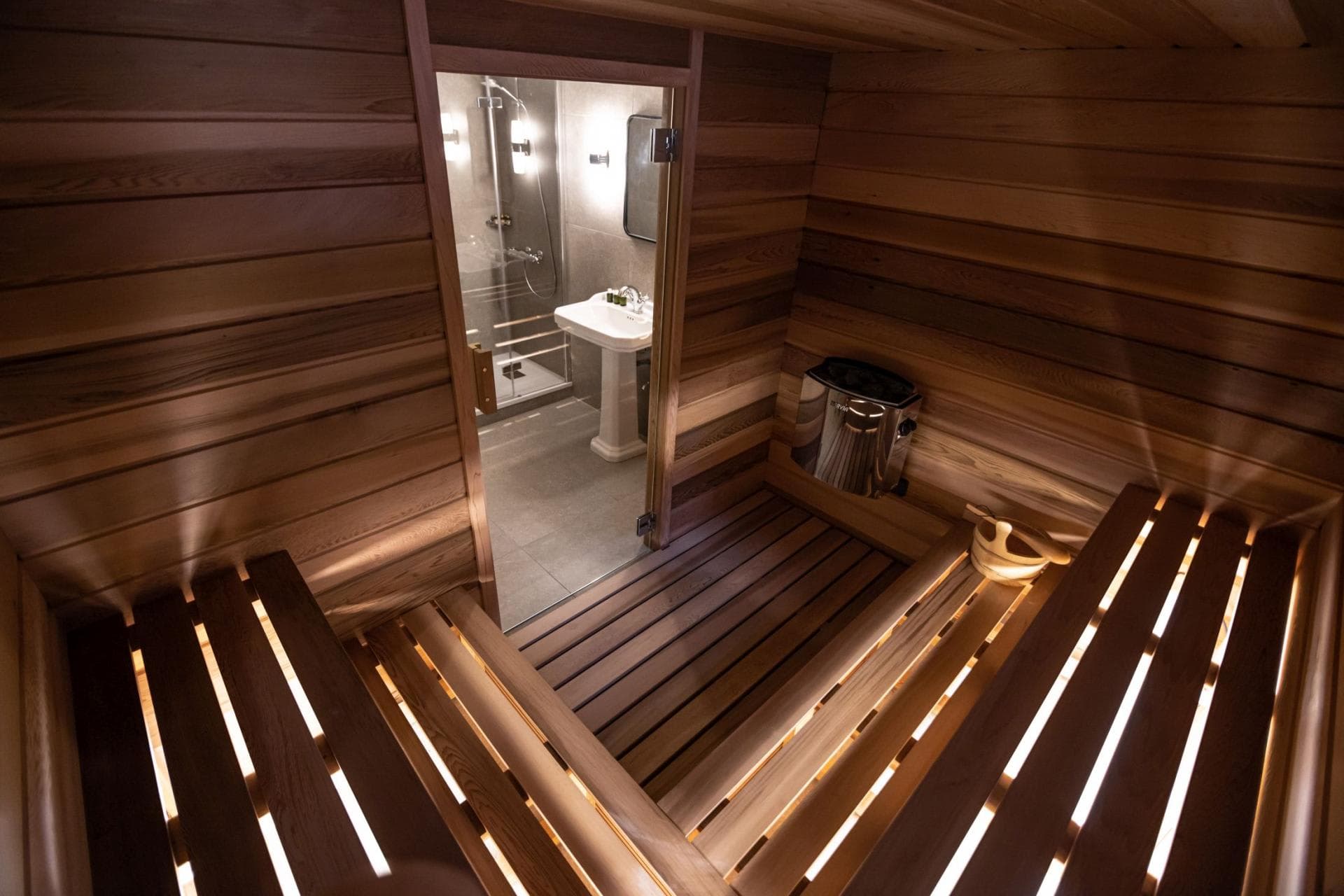 Cedar sauna with tiered seating and direct bathroom access