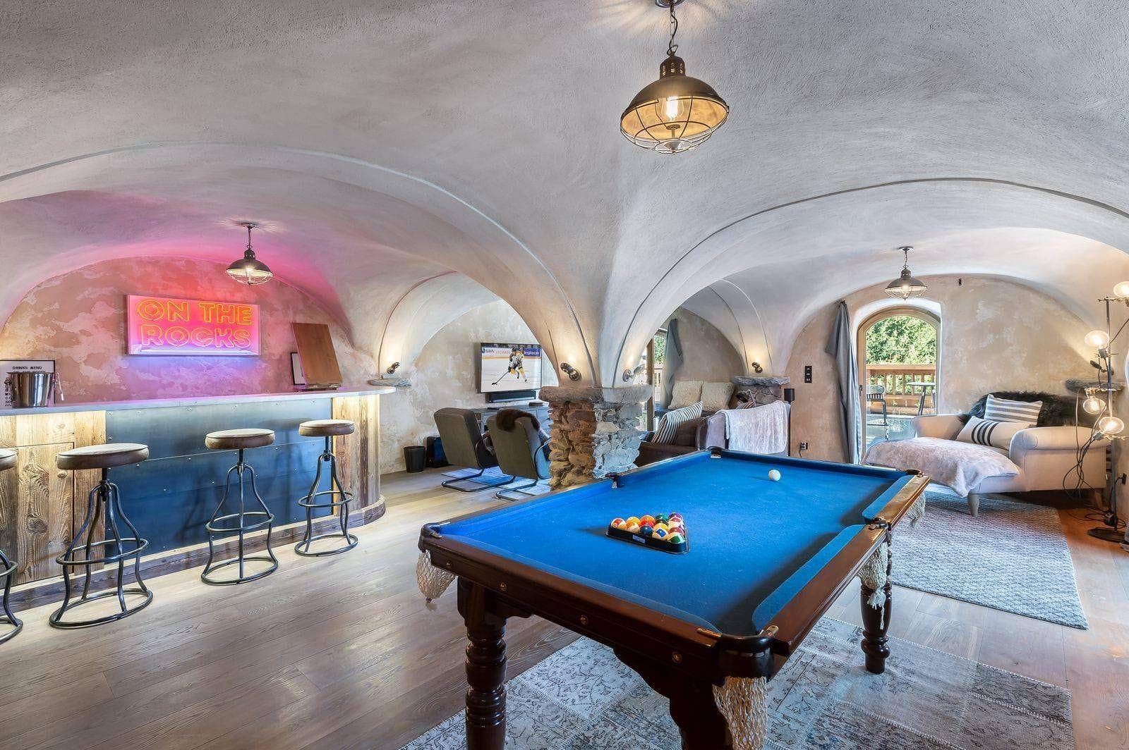 Vaulted billiards room with bar and lounge seating