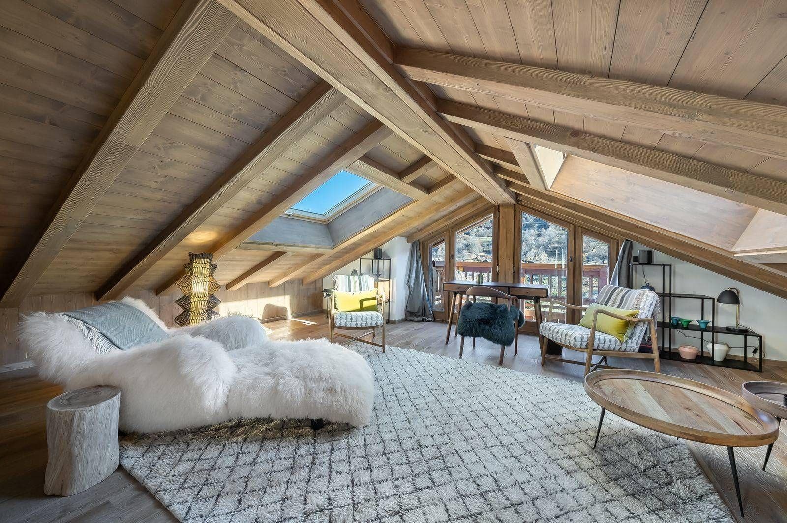 Top-floor lounge with skylights, desk and balcony doors