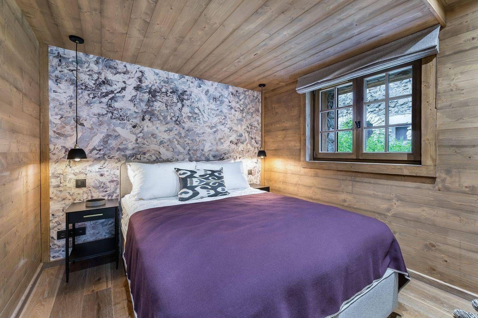 Double bedroom with timber wall and window