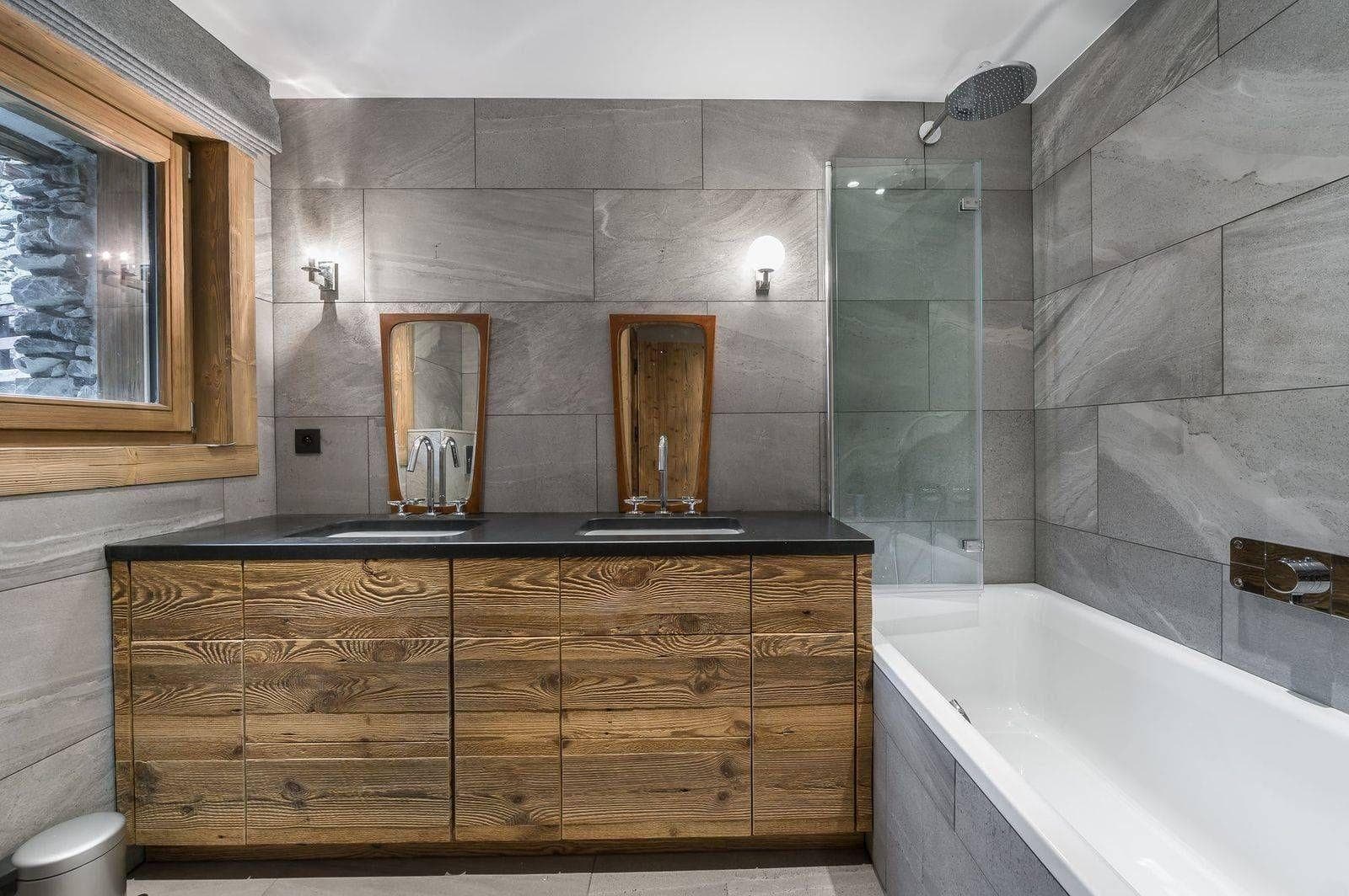 En-suite bathroom with bathtub and timber vanity