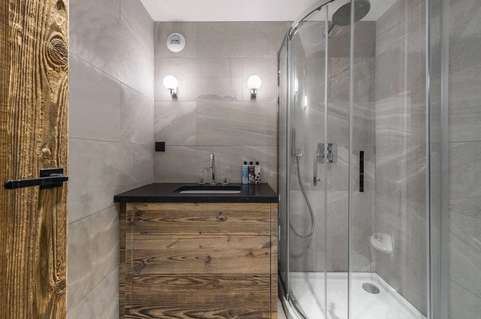 En-suite shower room with timber vanity and heated towel rail