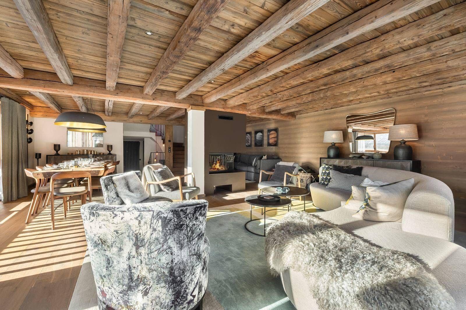 Open-plan lounge and dining room beneath exposed timber beams