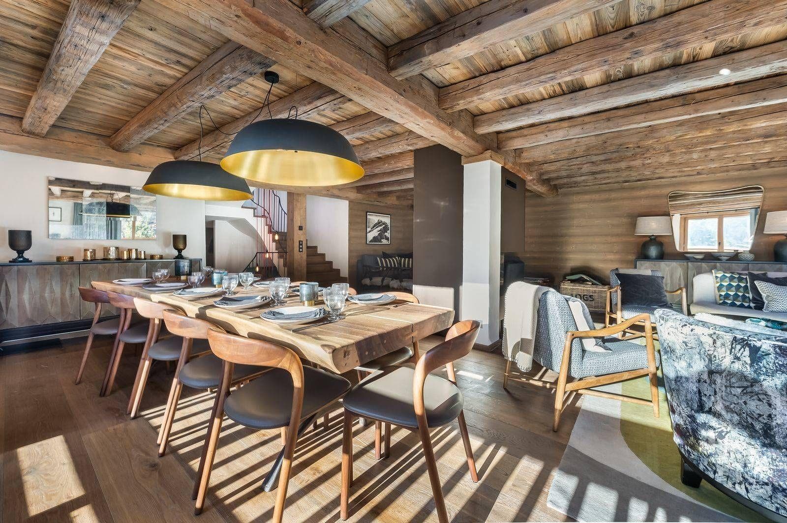 Dining table beneath exposed timber beams
