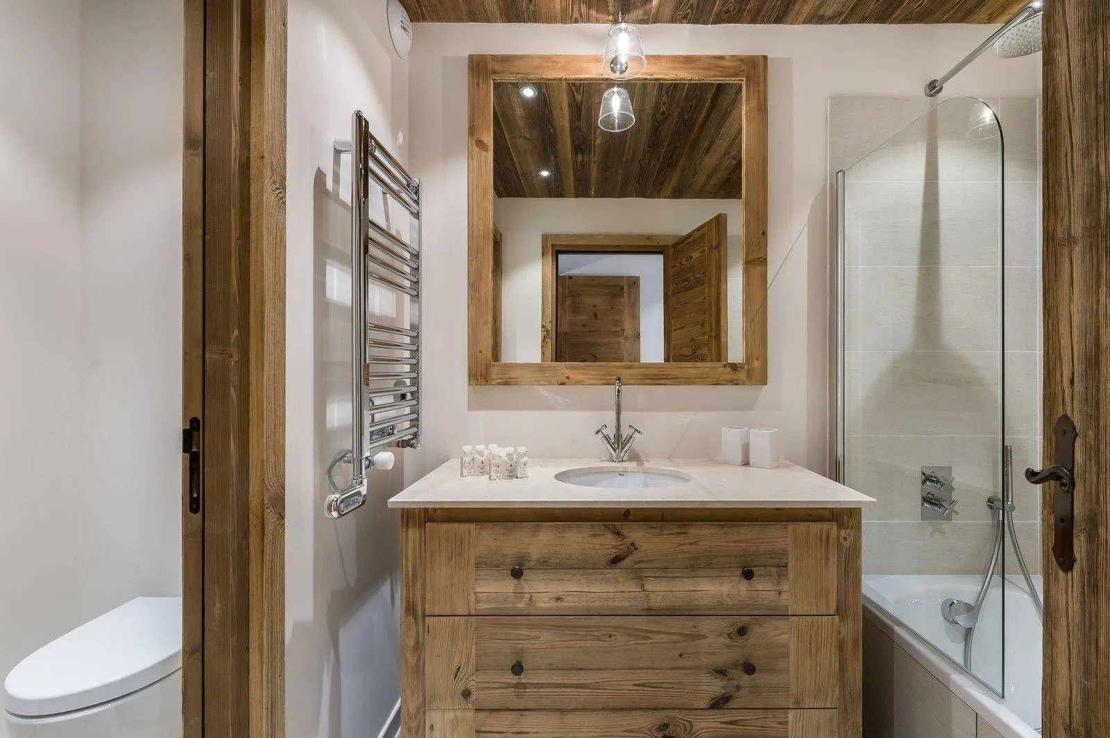 En-suite bathroom with a bathtub, single basin and heated towel rail