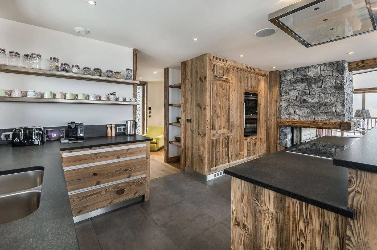 Open kitchen with induction hob, double ovens and breakfast-bar seating