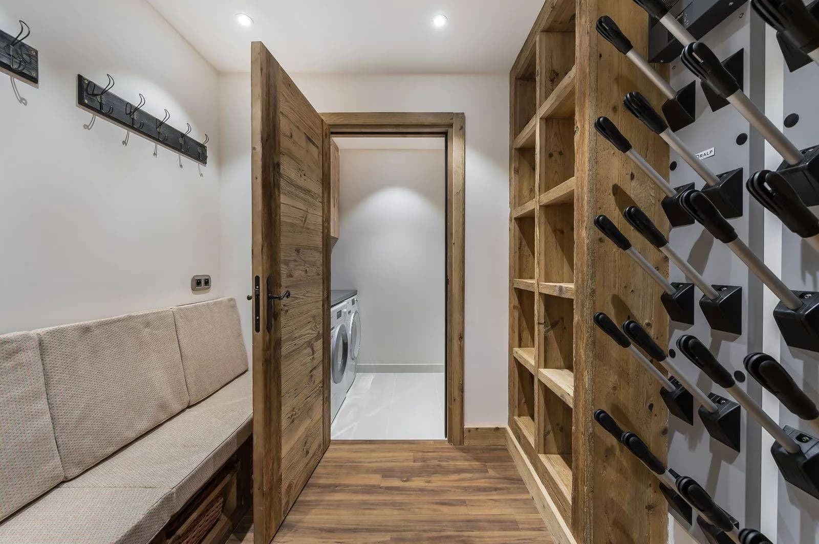 Ski room with bench seating and a heated boot rack
