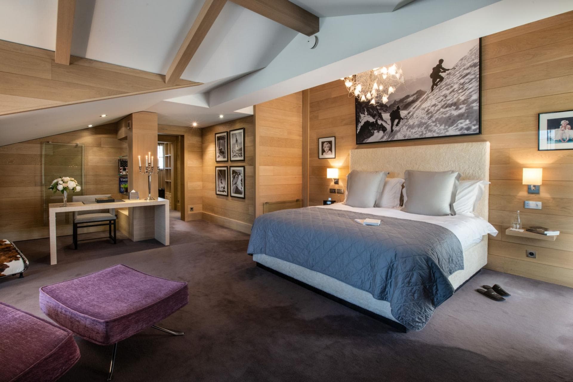 Primary bedroom with king bed, dedicated workspace, and vaulted ceilings