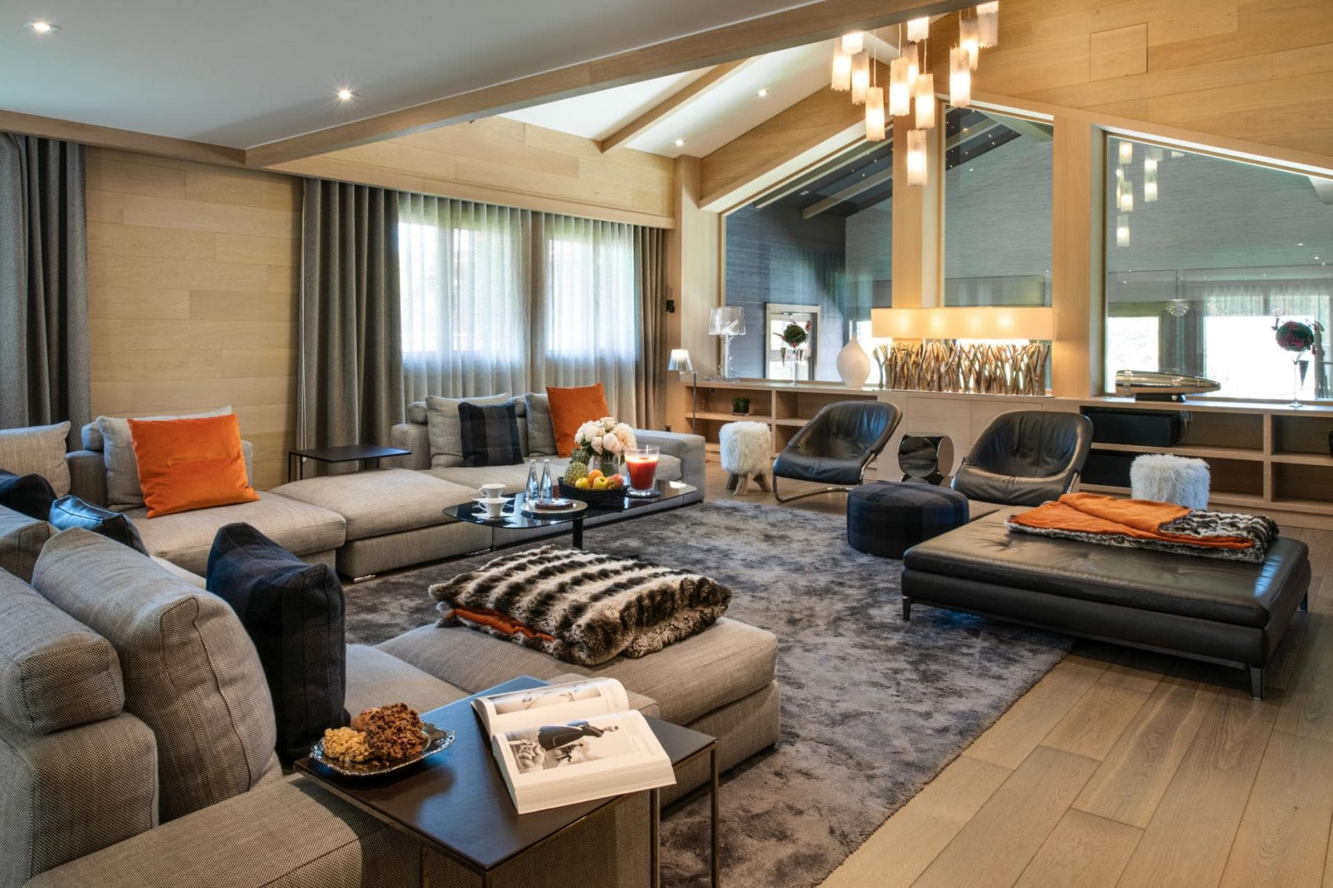 Living area with modular sectional seating and floor-to-ceiling windows