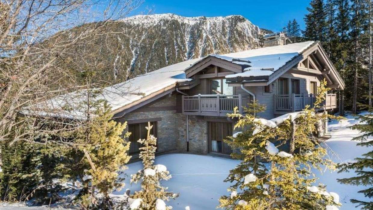 Timber and stone chalet exterior with private balconies and mountain views