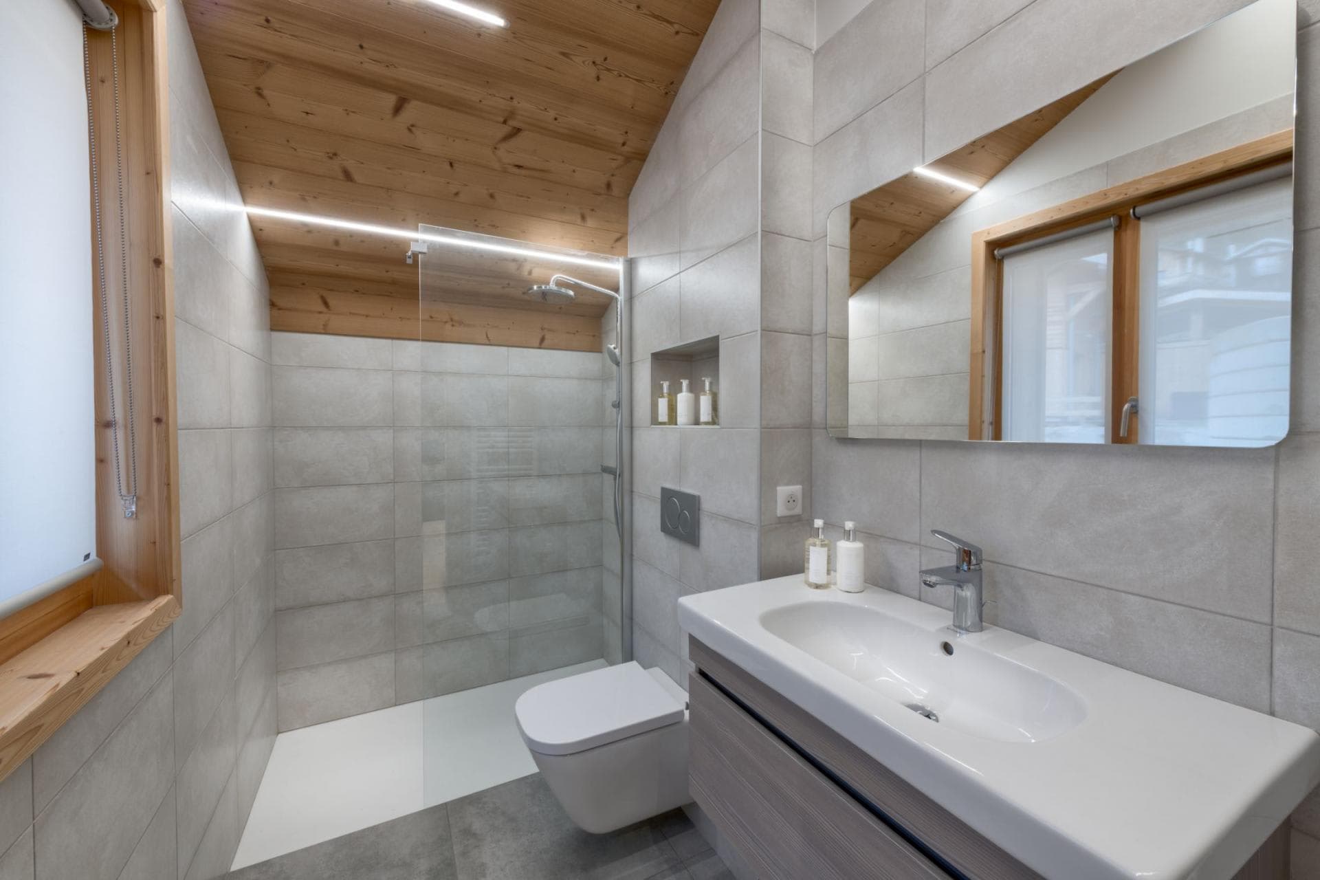 Bathroom with walk-in glass shower and wood-paneled ceiling