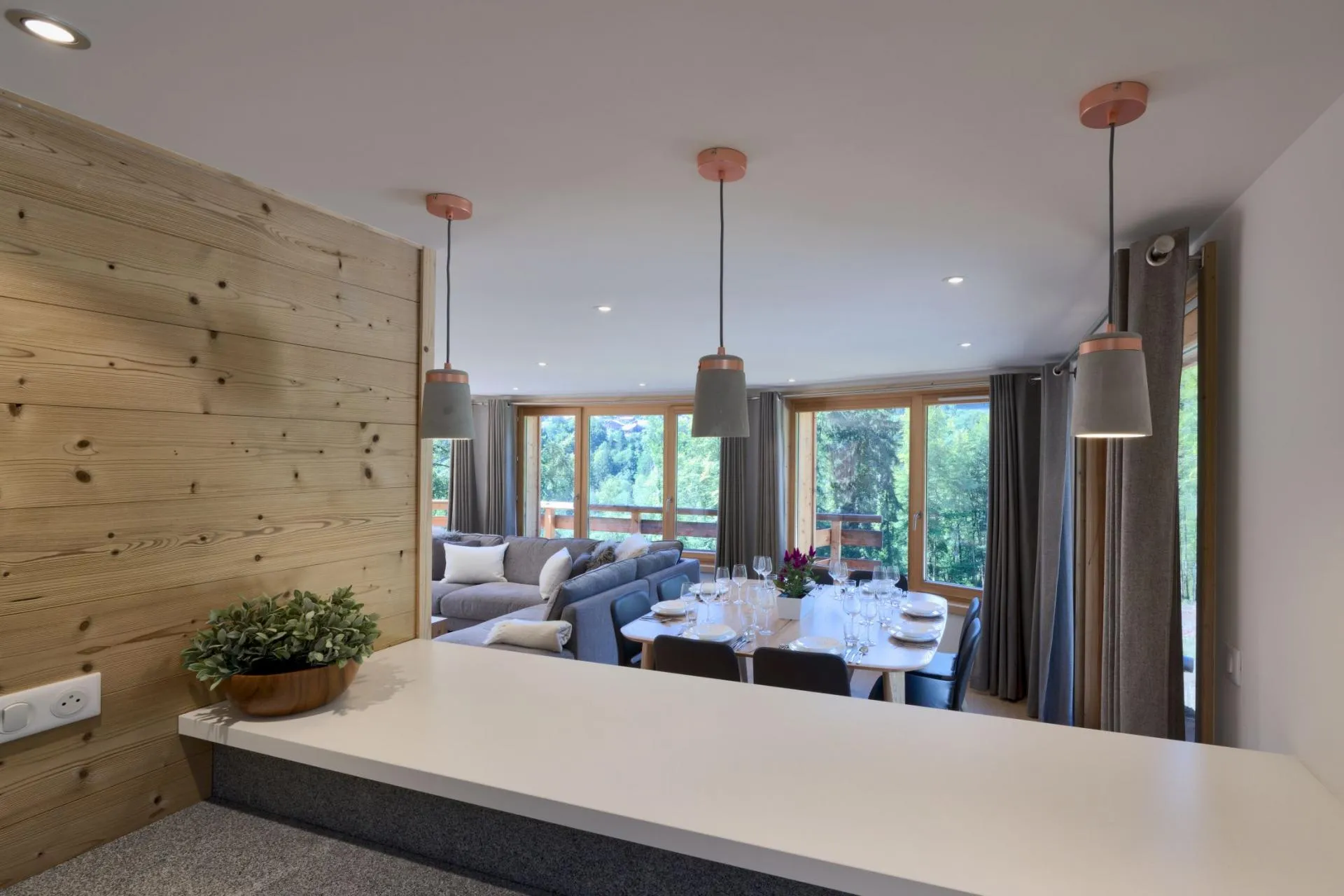 Dining table set for ten beside the open-plan living area