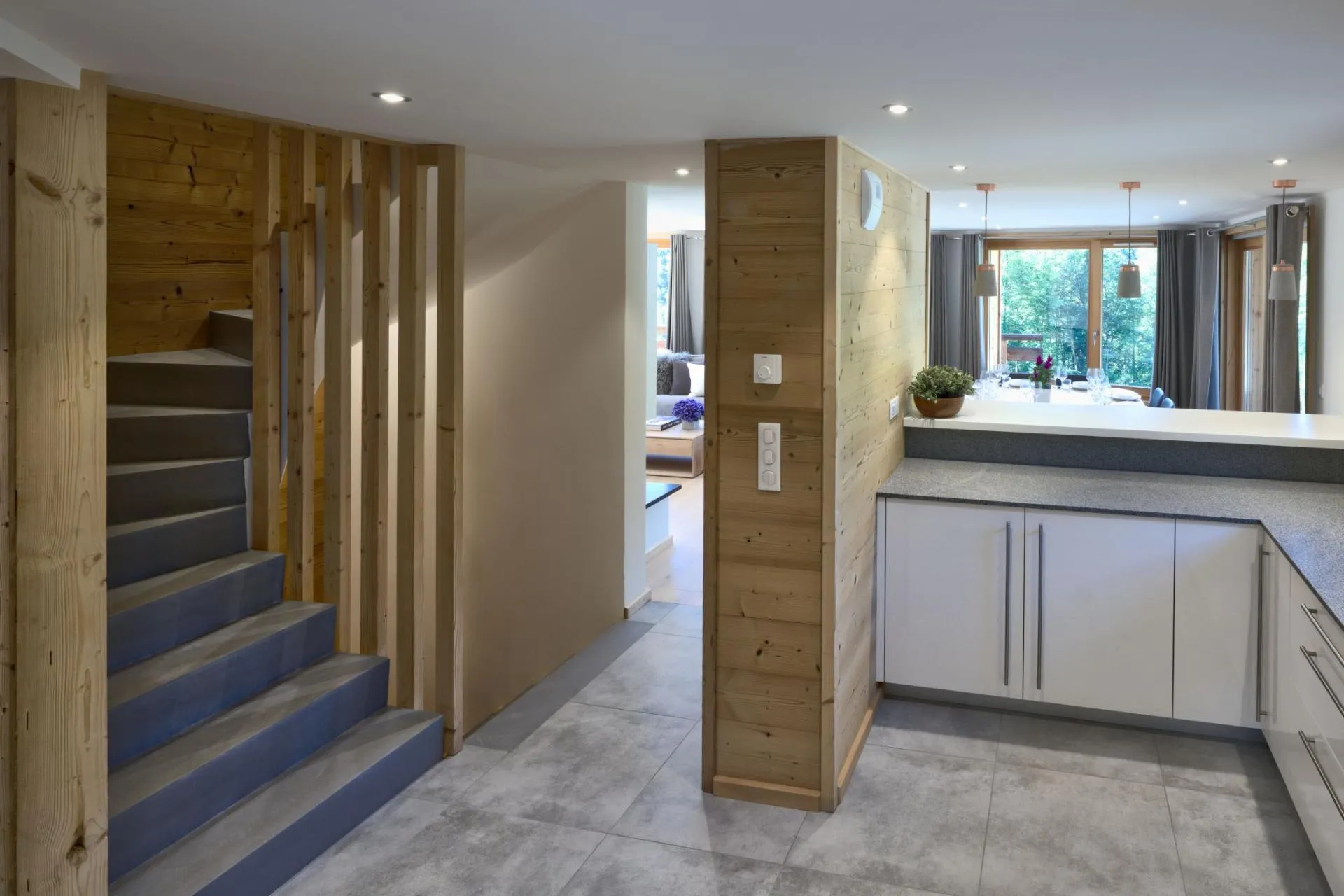 Kitchen with stone countertops and stairs to the upper level