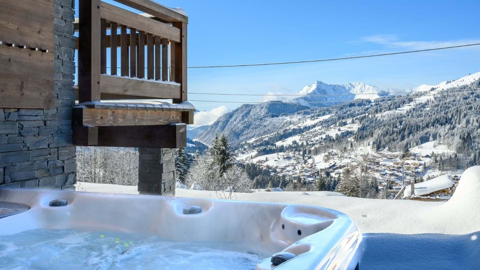 Outdoor hot tub with panoramic mountain and valley views