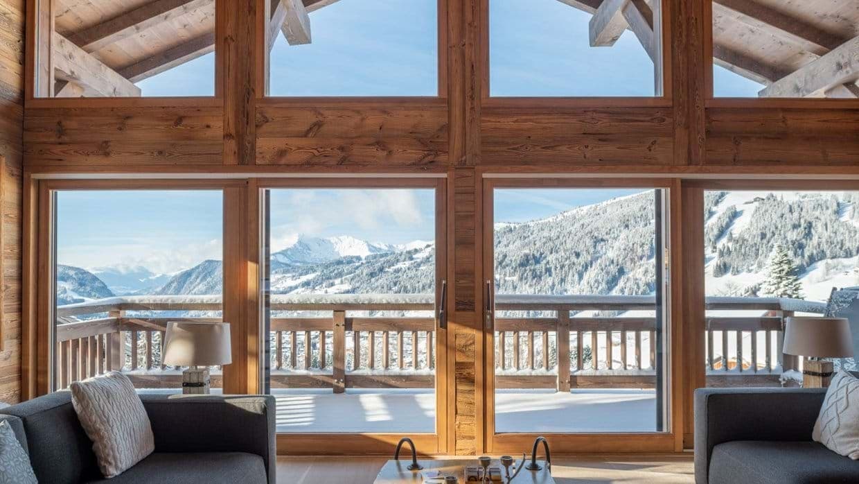 Living area with floor-to-ceiling windows and panoramic alpine views