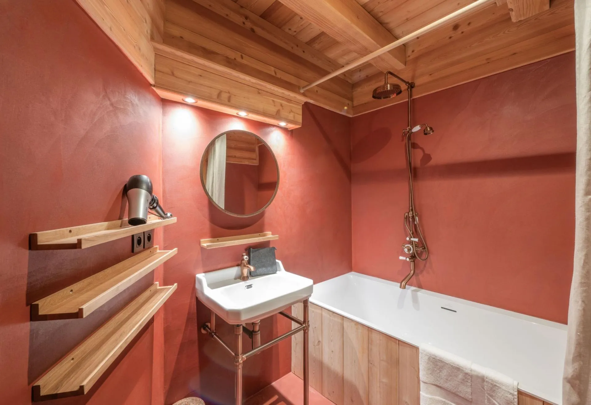 Bathroom with a timber-clad bathtub and rainfall shower
